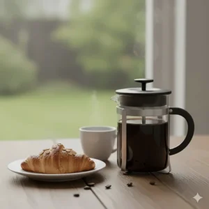 A small 3-cup cafetiere ideal for a single serving of coffee, shown next to a breakfast pastry.