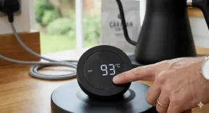 The digital LCD screen on a Fellow Stagg kettle showing precise temperature control in degrees Celsius.