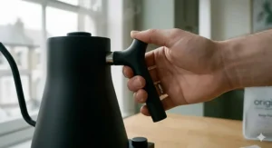 Detailed view of a heat-resistant, counterbalanced handle on a gooseneck kettle designed for comfort.