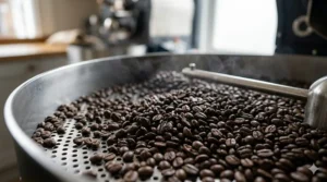 Fresh Colombian coffee beans cooling after being roasted to a rich dark brown colour.