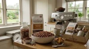 A steaming mug of coffee served beside a handful of caramel flavoured coffee beans.
