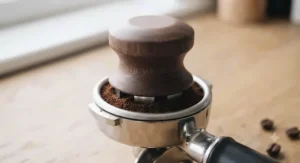 Matching coffee distributor tool included in the gift set for even grounds levelling.
