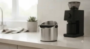 A small espresso knock box half-filled with discarded coffee pucks, demonstrating daily capacity.