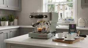 Classic Italian-style white porcelain espresso cups resting beside a gleaming home coffee machine.