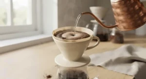 Hot water being poured over freshly ground coffee inside a budget-friendly paper filter.